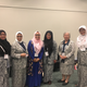 A group of Indonesian midwives at the conference, all but one of whom are wearing custom uniforms with a textile that designates their professional affiliation. Photo by Kathryn Jezer-Morton.